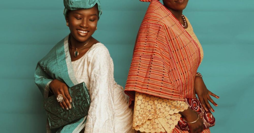 Pairings - Two Elegant Women in Maxi Dresses and Headscarves Posing in a Studio