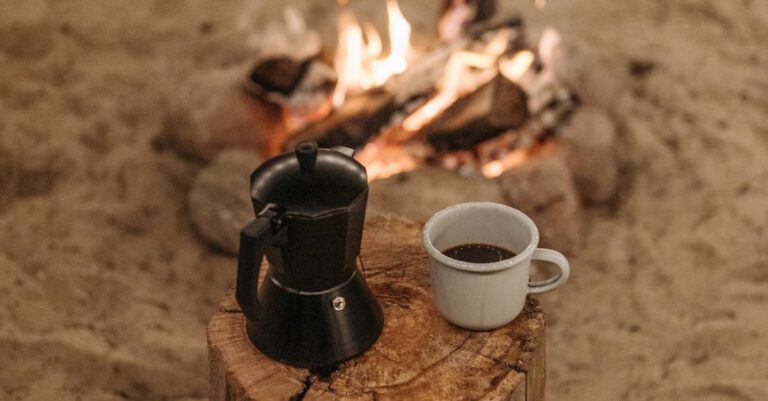 Makers - A Cup of Coffee on a Wooden Log Near the Bonfire