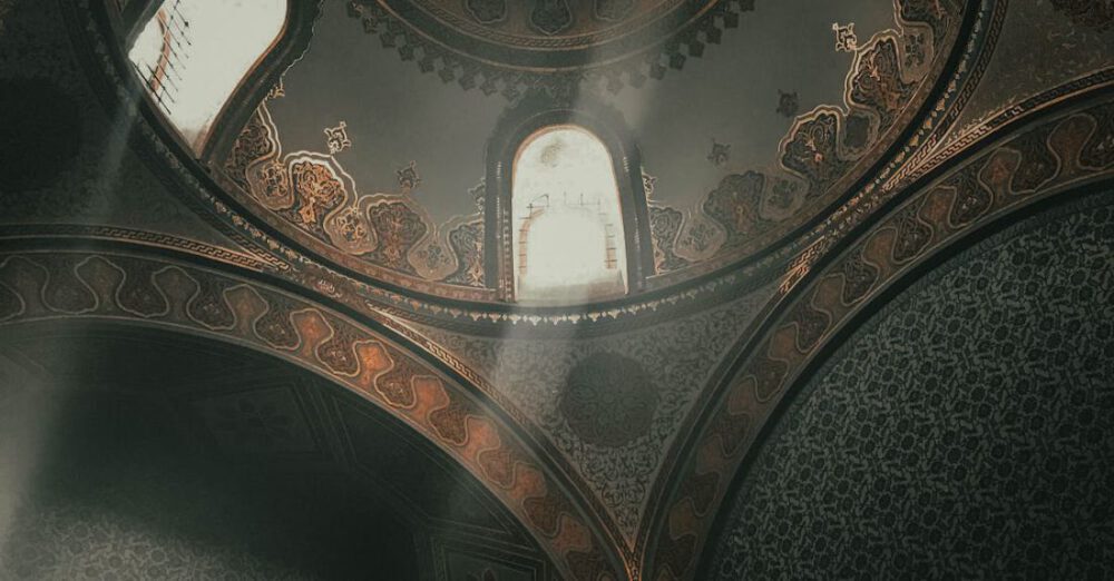 Visit - From below dome inside of ancient Topkapi Palace located in Istanbul decorated with arches and golden ornaments