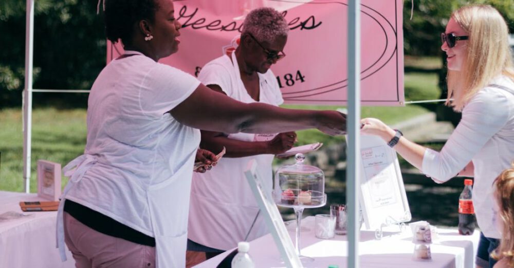 Stall - Two Women in White Shirts Beside Stall