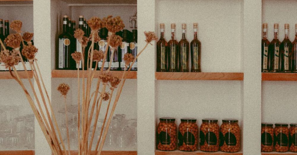 Preserves - Shelves of Jars with Preserves and Wine Bottles