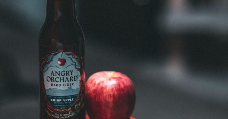 Cider - Angry Orchard Hard Cider Bottle Beside Red Apple Fruit